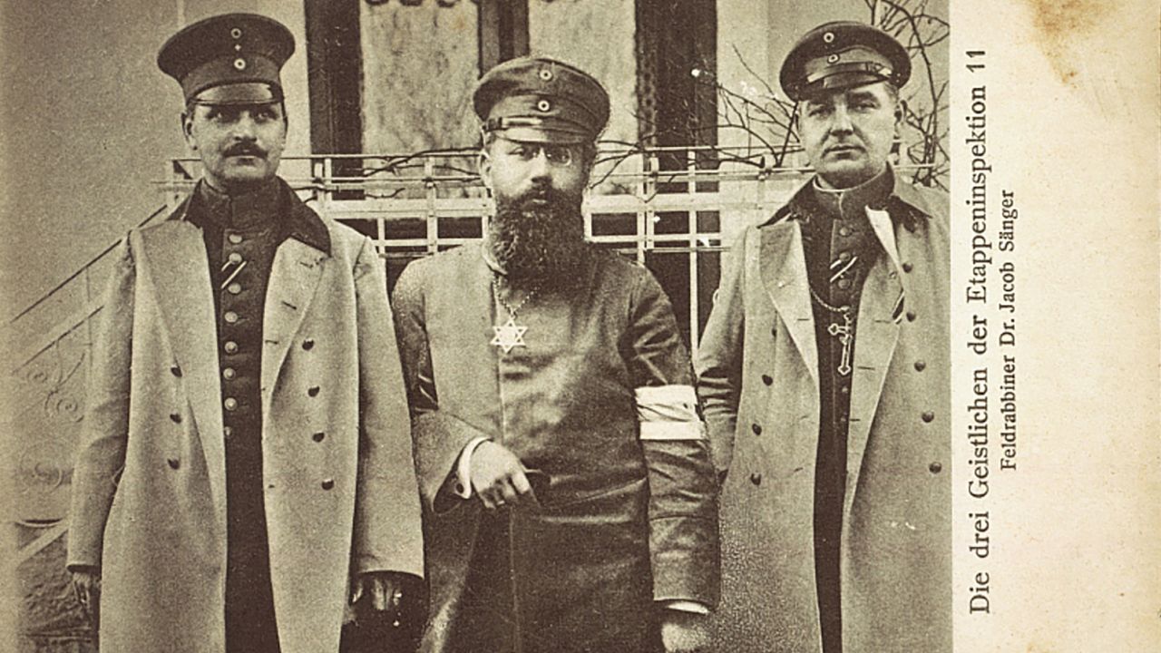 This photo postcard, issued around 1915 to 1916, shows military Jewish chaplain Dr. Jacob Sänger (middle). A Catholic and Protestant clergyman stand either side.