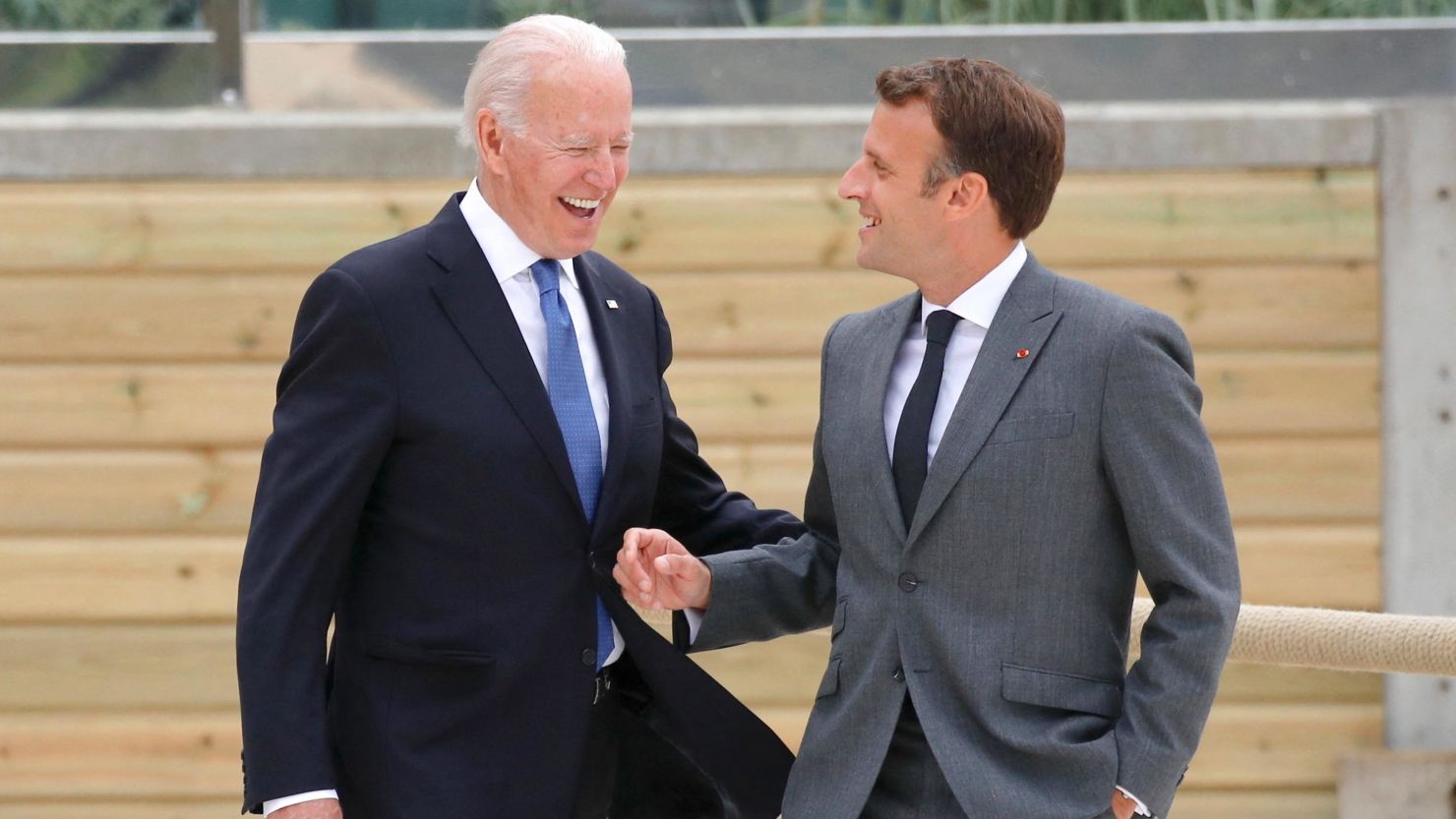 US President Joe Biden and France's President Emmanuel Macron walk along the boardwalk during the G7 summit in Carbis Bay, England on June 11, 2021. 