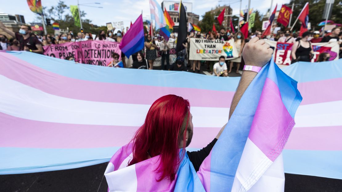 Protesters gather ahead of the Sydney Gay and Lesbian Mardi Gras parade next to a banner with the colors of the trans movement on March 6 in Australia.