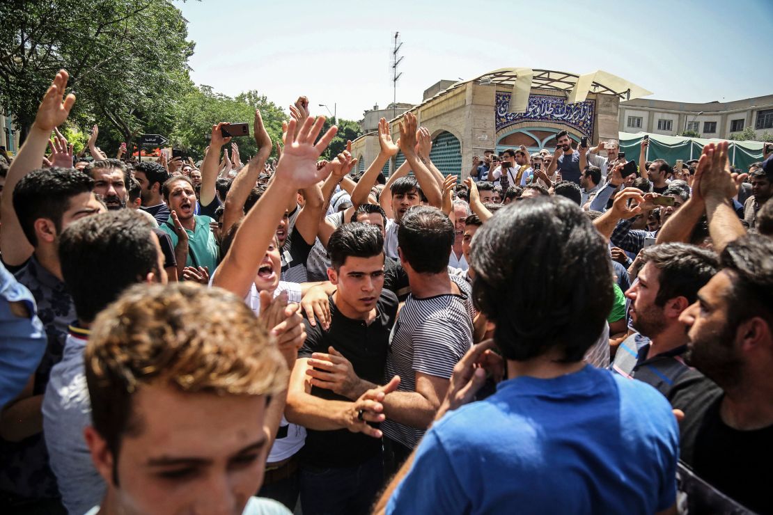 In this June 2018 photo, a group of protesters chant slogans at the main gate of the Old Grand Bazaar, in Tehran, Iran. The case of 27-year-old Navid Afkari has drawn the attention of a social media campaign that portrays him and his brothers as victims targeted over participating in protests against Iran's Shiite theocracy in 2018. 