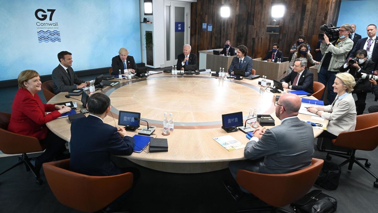 US President Joe Biden, Canada's Prime Minister Justin Trudeau, Italy's Prime minister Mario Draghi, President of the European Commission Ursula von der Leyen, President of the European Council Charles Michel, Japan's Prime Minister Yoshihide Suga, Germany's Chancellor Angela Merkel, France's President Emmanuel Macron and British Prime Minister Boris Johnson sit around the table at the start of the G7 summit in Carbis Bay, Cornwall on June 11, 2021.