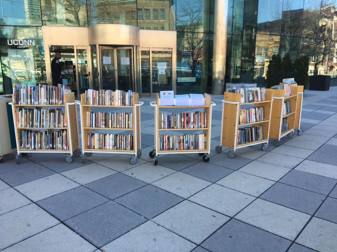 Racks of books are seen during the pandemic in front of the Hartford Public Library, where librarians have had to reimagine the services they offer.