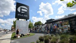 A visitor leaves a flower and messages at the onePULSE Foundation's Pulse Interim Memorial, Friday, June 12, 2020, in Orlando, Fla. Friday marked the fourth anniversary of the Pulse nightclub shooting. (Phelan M. Ebenhack via AP)