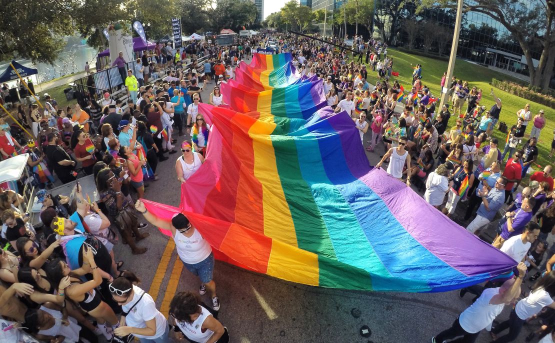 Participants in the Come Out With Pride Orlando Parade carry a massive pride flag in 2016, a few months after the Pulse shooting. 