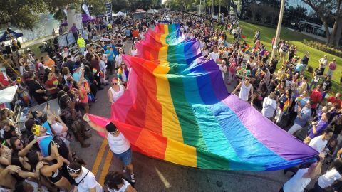 Participants in the Come Out With Pride Orlando Parade carry a massive pride flag in 2016, a few months after the Pulse shooting. 