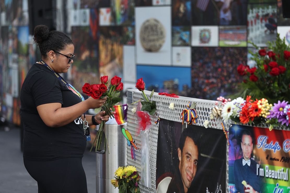 A woman places flowers on a fence at the memorial set up for the shooting victims at Pulse in 2018, two years after the shooting. 