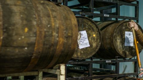 Town Branch Distillery's blender and distiller Alan Kennedy uses a whiskey thief to extract bourbon from a freshly tapped barrel.