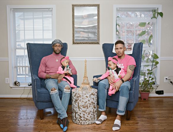 Vernon and Ricardo with their twin girls at home. Clinton, Maryland.