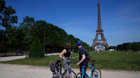 Cyclists take a look at the Eiffel Tower in Paris, Wednesday, June 9, 2021. 