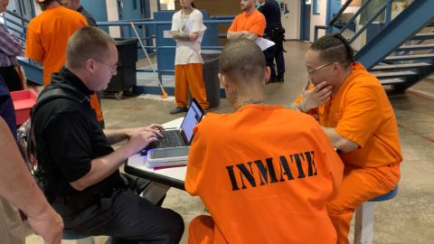 Inmates at the North Fork Correctional Center learn to use their tablets.