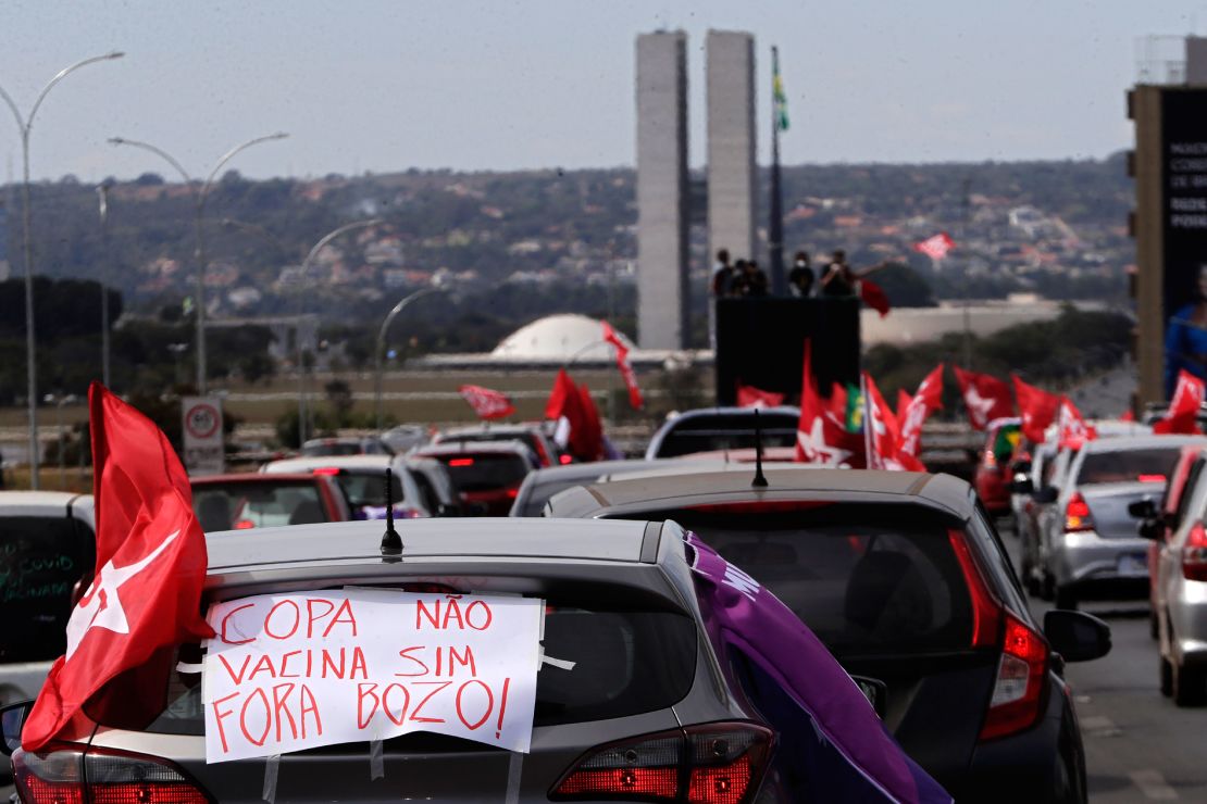 A sign reads in Portuguese "Copa No. Vaccine Yes, Out Bolsonaro" during a protest against the President's handling of the Covid-19 pandemic in Brasilia on Sunday.