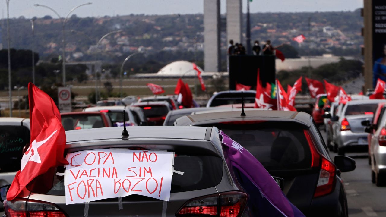 A sign reads in Portuguese "Copa No. Vaccine Yes, Out Bolsonaro" during a protest against the President's handling of the Covid-19 pandemic in Brasilia on Sunday.