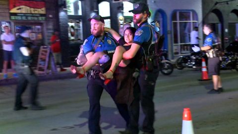A person injured in the shooting is carried to safety.