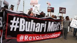 Protesters hold banners during a demonstration in Nigerian capital Abuja on Saturday, as activists called for nationwide protests against the government of President Muhammadu Buhari. 