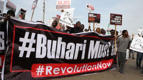 Protesters hold banners during a demonstration in Nigerian capital Abuja on Saturday, as activists call for nationwide protests against the government of President Muhammadu Buhari. 