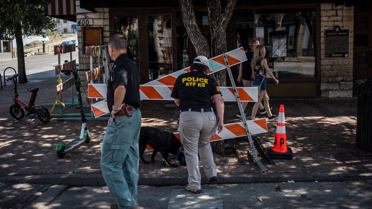 An ATF K9 unit surveys the area near the scene of the shooting
