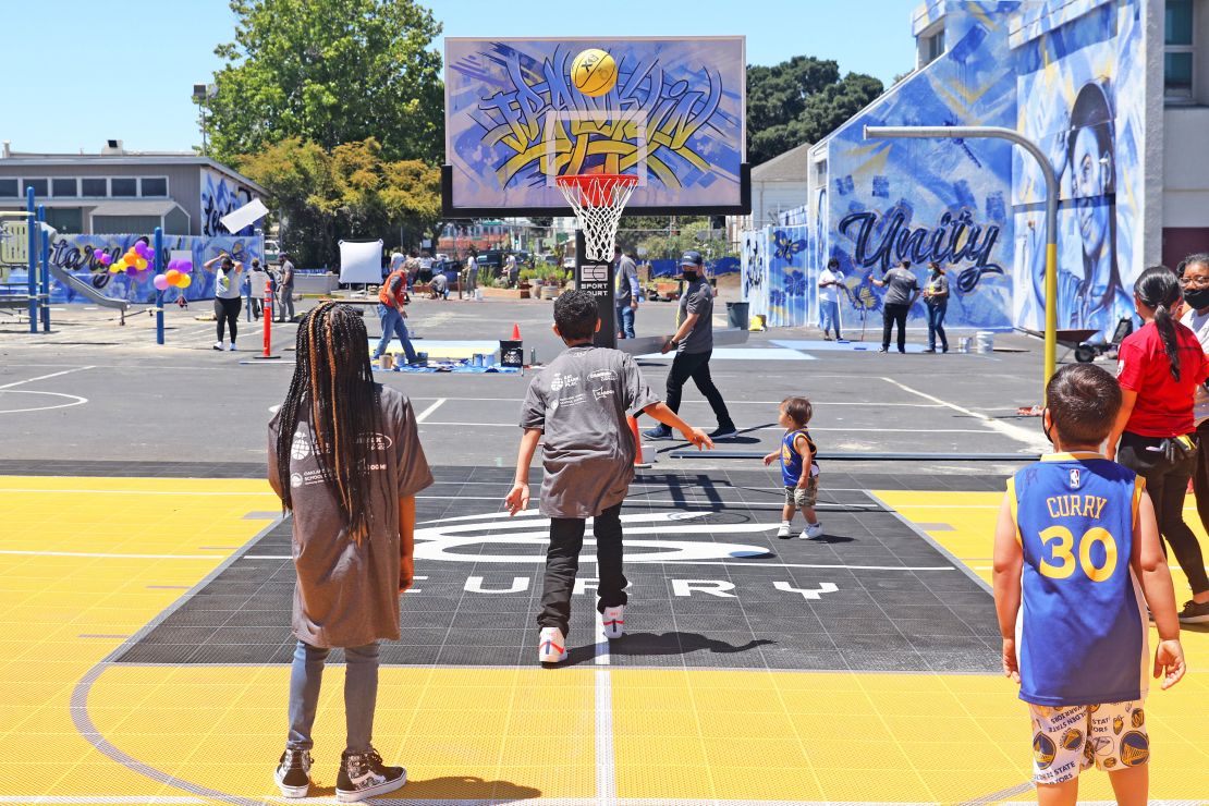 Kids play on the new basketball court.