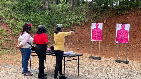 Three women attend a shooting event put on by the National African American Gun Association at a range in Covington, Georgia, on Sunday, June 13, 2021. 