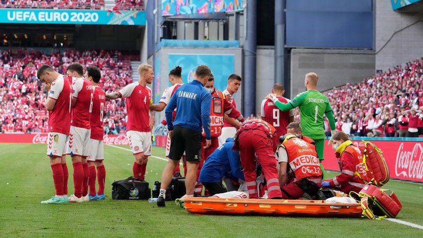 COPENHAGEN, DENMARK - JUNE 12: Christian Eriksen (Hidden) of Denmark receives medical treatment during the UEFA Euro 2020 Championship Group B match between Denmark and Finland on June 12, 2021 in Copenhagen, Denmark. (Photo by Martin Meissner - Pool/Getty Images)