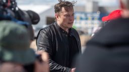 Elon Musk (l), Tesla CEO, stands on the construction site of the Tesla factory and talks to visitors. He has taken a look at the construction progress of the new factory in Grünheide near Berlin, which will probably start production several months later than originally planned.