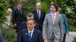 ST AUSTELL, ENGLAND - JUNE 11:  German Chancellor Angela Merkel, French President Emmanuel Macron,  Japanese Prime Minister Yoshihide Suga, Queen Elizabeth II, Canadian Prime Minister Justin Trudeau, Italian Prime Minister Mario Draghi,and United States President Joe Biden arrive for a drinks reception for Queen Elizabeth II and G7 leaders at The Eden Project during the G7 Summit on June 11, 2021 in St Austell, Cornwall, England. UK Prime Minister, Boris Johnson, hosts leaders from the USA, Japan, Germany, France, Italy and Canada at the G7 Summit. This year the UK has invited India, South Africa, and South Korea to attend the Leaders' Summit as guest countries as well as the EU. (Photo by Jack Hill - WPA Pool / Getty Images)