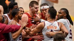 Nikola Jokic #15 of the Denver Nuggets and Devin Booker #1 of the Phoenix Suns exchange words after a play that would result in Jokic being ejected in the third quarter in Game Four of the Western Conference second-round playoff series at Ball Arena on June 13, 2021 in Denver, Colorado. 