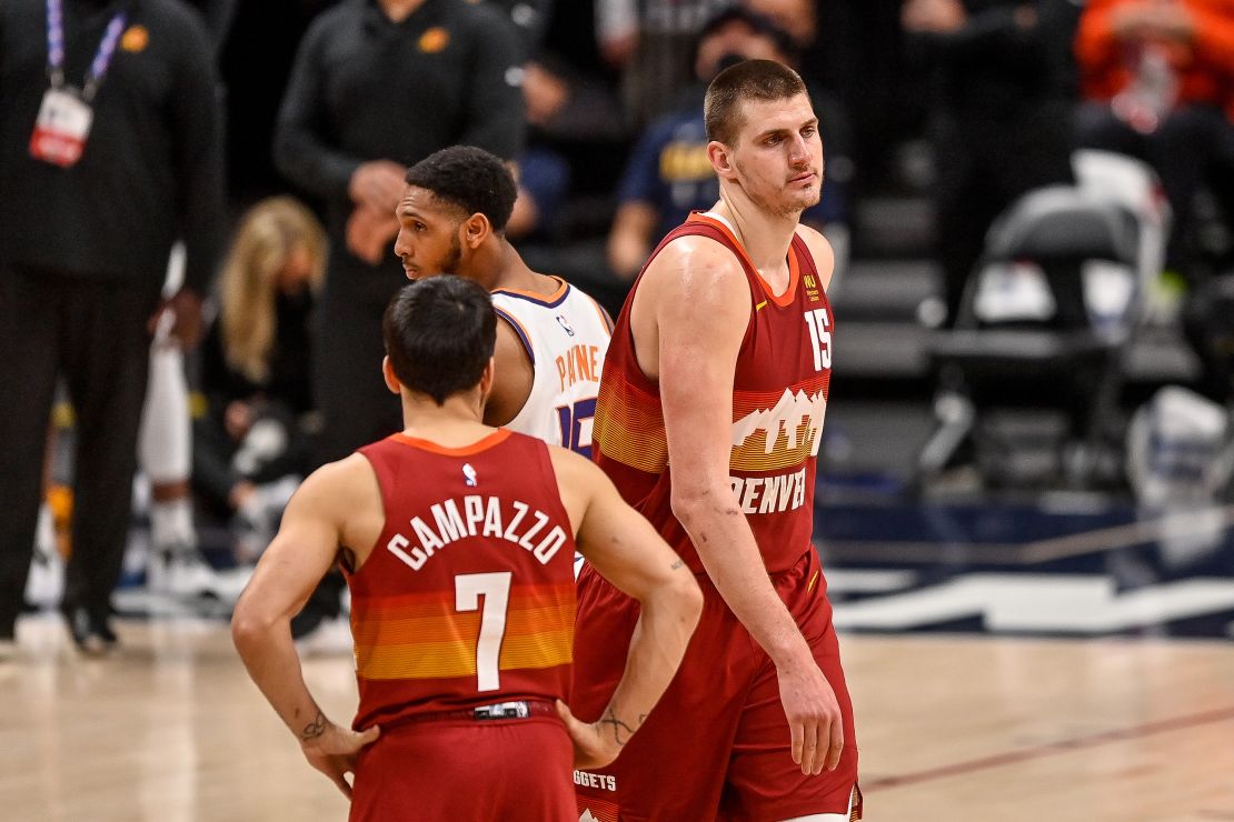 Jokic walks off the court after being ejected.