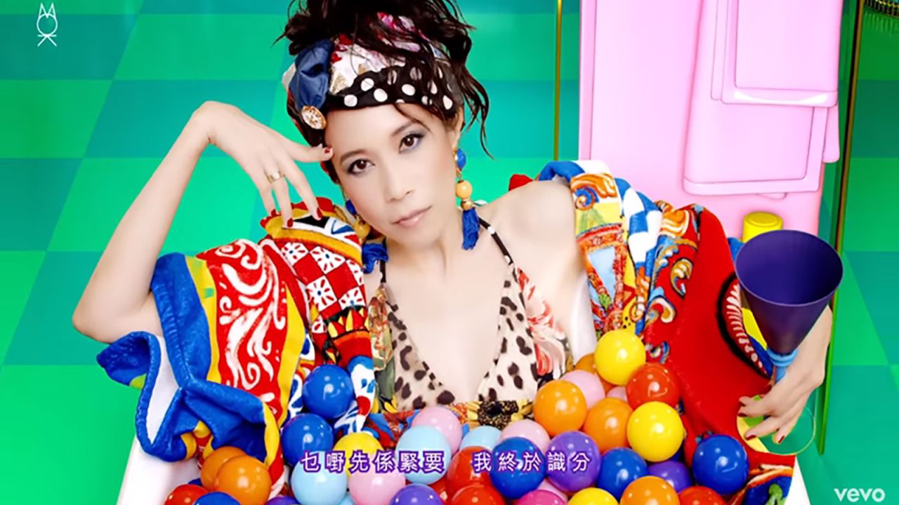 Karen Mok wearing D&G in her music video "A Woman for All Seasons."