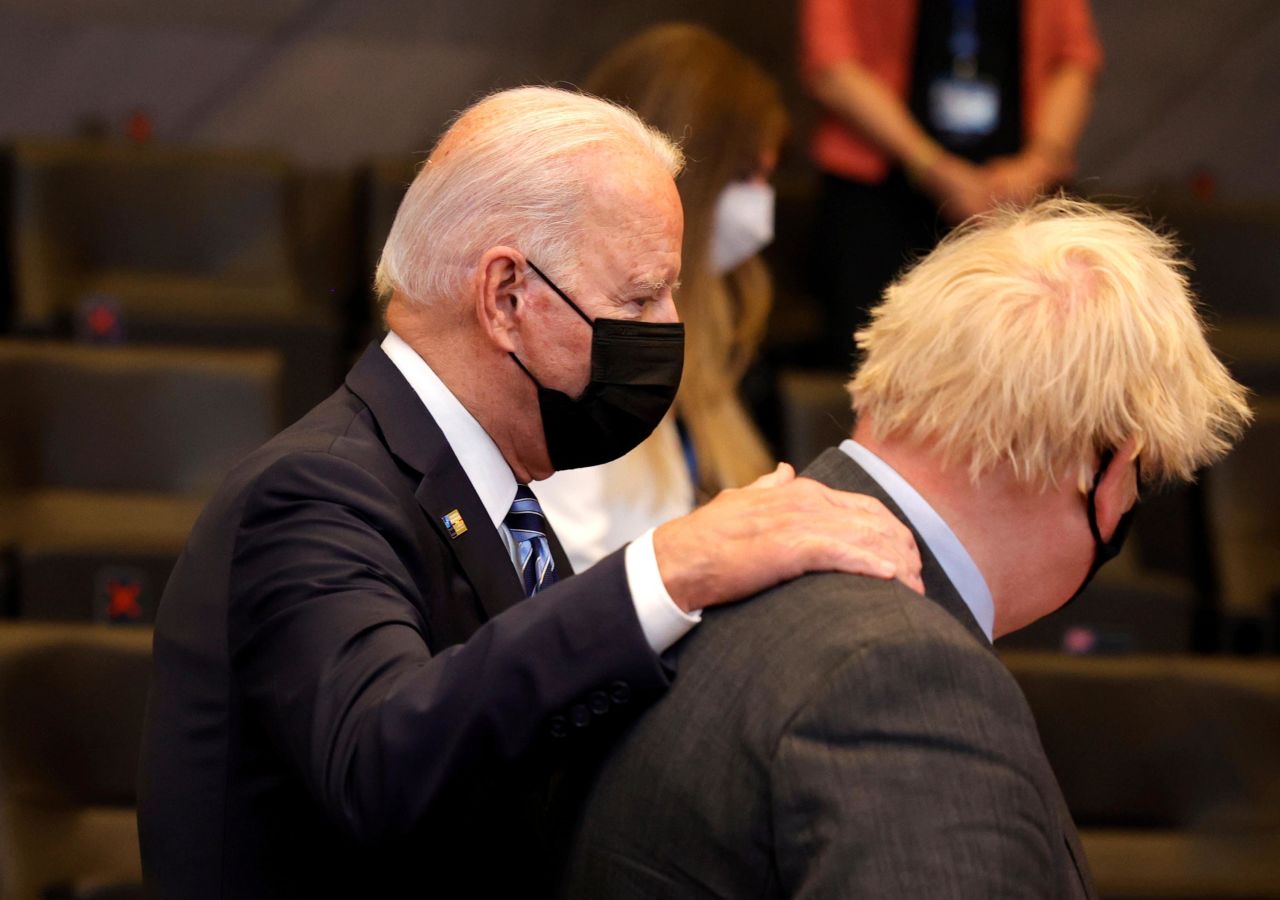 Biden puts his hand on the shoulder of British Prime Minister Boris Johnson during the NATO summit on Monday.