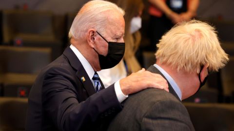 Biden puts his hand on the shoulder of British Prime Minister Boris Johnson during the NATO summit on Monday.