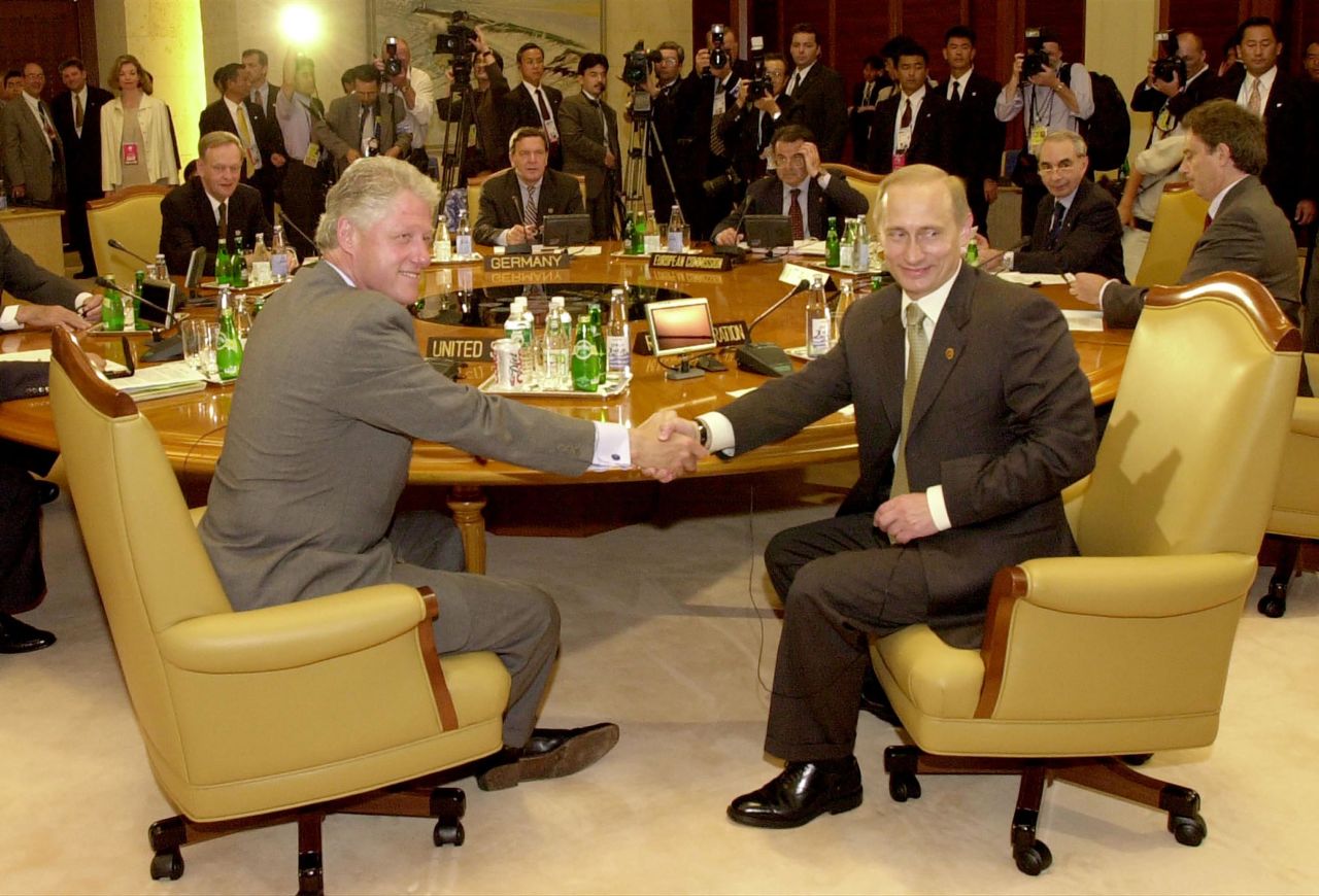 Clinton shakes hands with new Russian President Vladimir Putin before the start of a G8 summit in Japan in 2000.