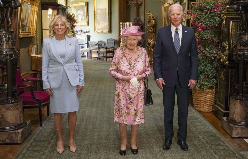 Britain's Queen Elizabeth II, center, poses with US President Joe Biden and first lady Jill Biden in the Grand Corridor of Windsor Castle in June 2021.