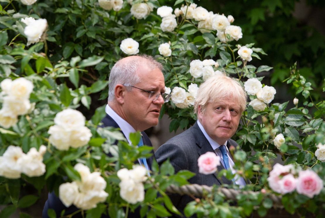 Britain's Prime Minister Boris Johnson (R) and Australia's Prime Minister Scott Morrison walk in the garden of 10 Downing street in central London on June 15, 2021.