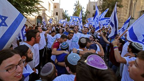 Israelis lift flags as they gather near Jerusalem's Old City ahead of the flag march on Tuesday.