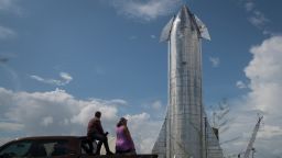 Space enthusiasts look at a prototype of SpaceX's Starship spacecraft at the company's Texas launch facility on September 28, 2019 in Boca Chica near Brownsville, Texas. The Starship spacecraft is a massive vehicle meant to take people to the Moon, Mars, and beyond. (Photo by Loren Elliott/Getty Images)