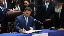 SURFSIDE, FLORIDA - JUNE 14: Florida Gov. Ron DeSantis signs two bills at the Shul of Bal Harbour on June 14, 2021 in Surfside, Florida. The bills are HB 529 and HB 805. HB 805 ensures that volunteer ambulance services, including Hatzalah, can operate. HB 529 requires Florida schools to hold a daily moment of silence. (Photo by Joe Raedle/Getty Images)