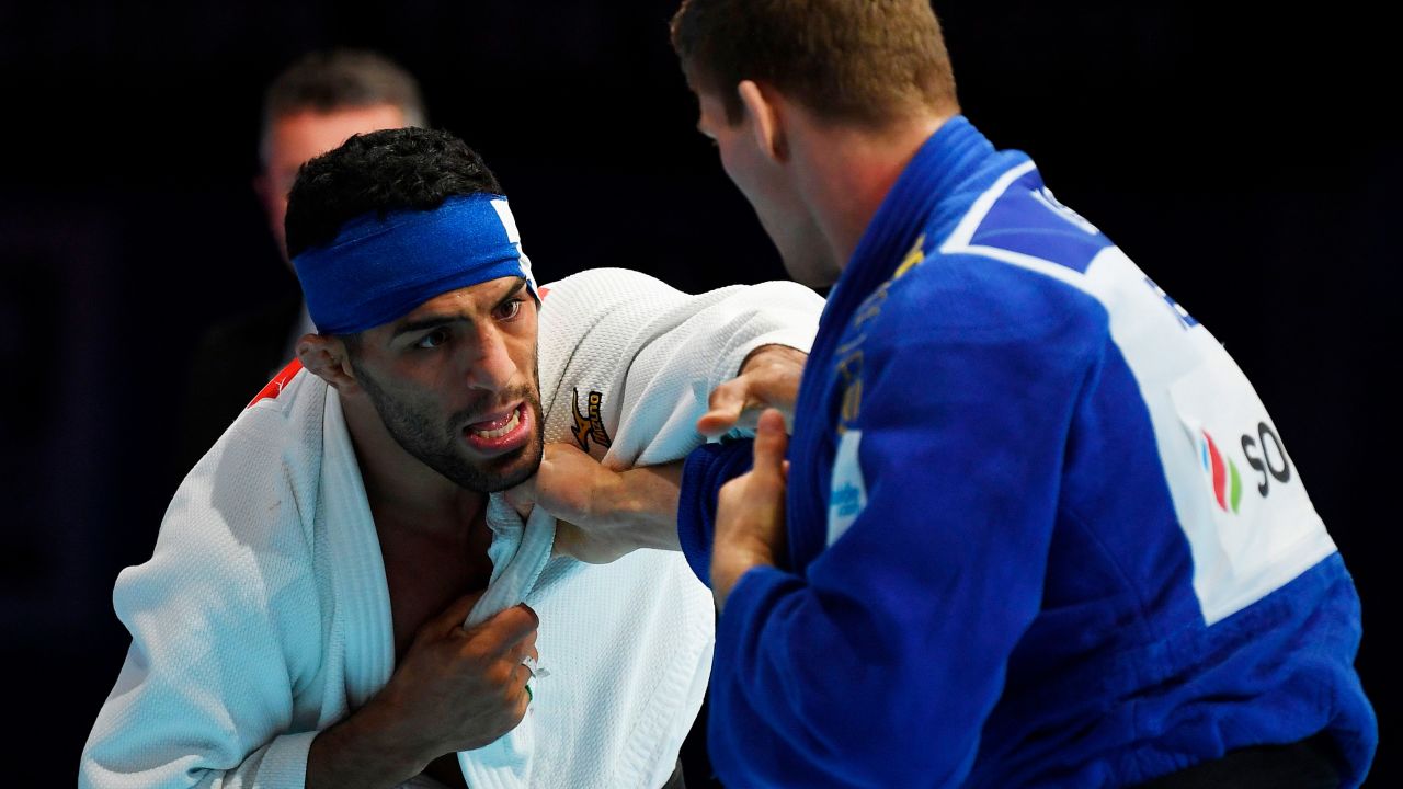 Iran's Saeid Mollaei (in white) fights against Belgium's Matthias Casse during the semifinal of the men's under 81kg category during the 2019 Judo World Championships at the Nippon Budokan, a venue for the upcoming Tokyo 2020 Olympic Games. Mollaei, who claimed he was ordered to deliberately lose a world championship fight, could compete under a refugee flag at the 2020 Tokyo Olympics, officials said on September 1.  