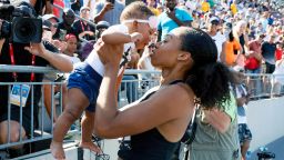 FILE - In this July 27, 2019, file photo, Allyson Felix holds her daughter Camryn after running the women's 400-meter dash final at the U.S. Championships athletics meet in Des Moines, Iowa. Early in her career, Allyson Felix would shy away from speaking on controversial subjects. The nine-time Olympic medalist stayed in her lane. Not anymore. Not since the birth of her daughter, Camryn. Felix wants her legacy to be improving maternity rights for athletes over her times and gold medals. "I feel like I'm right where I'm supposed to be," Felix said. "I feel stronger than ever, just with everything I've been through."(AP Photo/Charlie Neibergall, File)