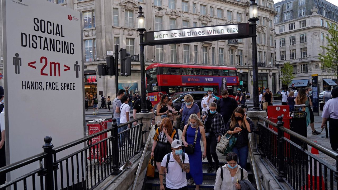 Commuters wearing face coverings due to Covid-19, enter Oxford Circus London Underground station in central London on June 7, 2021. - The Delta variant of the coronavirus, first discovered in India, is estimated to be 40 percent more transmissible than the Alpha variant that caused the last wave of infections in the UK, Britain's health minister said Sunday. (Photo by Niklas HALLE'N / AFP) (Photo by NIKLAS HALLE'N/AFP via Getty Images)