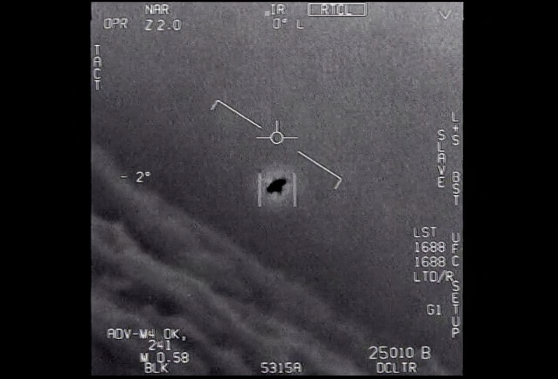 The image from video provided by the Department of Defense shows an unexplained object as it soars high along the clouds, traveling against the wind. 