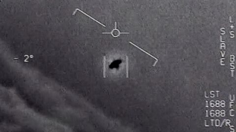 The image from video provided by the Department of Defense shows an unexplained object as it soars high along the clouds, traveling against the wind. 