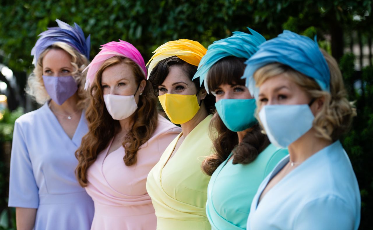 A group of attendees expertly coordinated in their looks, right down matching face-coverings.