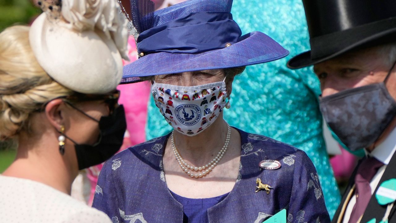 Princess Anne wore a deep blue ensemble with a bespoke face covering on the first day of Royal Ascot. 