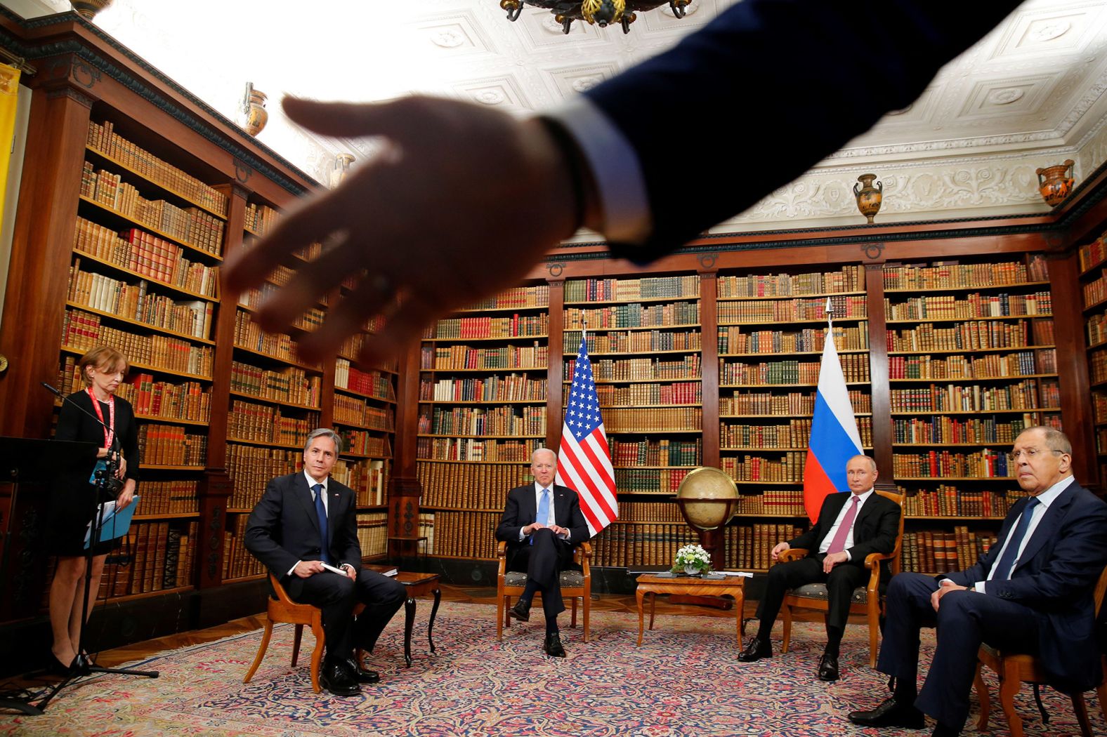 A security officer asks the media to step back at the start of the summit. There was a <a href="https://www.cnn.com/world/live-news/biden-putin-meeting-geneva-updates-intl/h_3e857d8407c5e20318786fdc3ef7115d" target="_blank">chaotic scrum of reporters</a> from both countries during the photo op, and the situation got incredibly tense between the two traveling press corps, according to CNN Chief White House Correspondent Kaitlan Collins. Reporters were seen blocking cameras as the two presidents were trying to give their opening remarks to each other. Sitting with the presidents here are US Secretary of State Antony Blinken, left, and Russian Foreign Minister Sergey Lavrov.