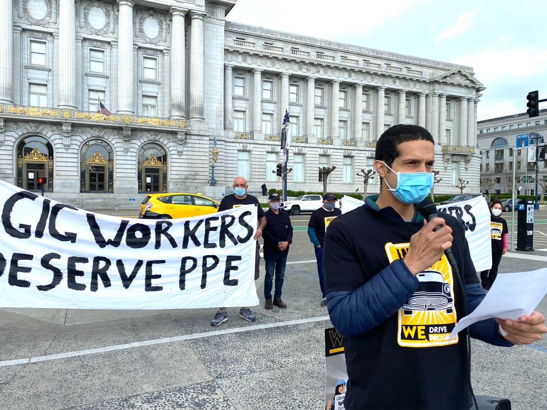 Uber driver Lucas Chamberlain speaks outside San Francisco City Hall about the need for gig companies to provide PPE and pay for time spent cleaning their vehicles at a ___ 2020 rally.