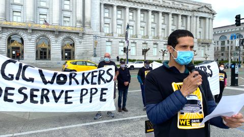 Uber driver Lucas Chamberlain speaks outside San Francisco City Hall about the need for gig companies to provide PPE and pay for time spent cleaning their vehicles at a ___ 2020 rally.