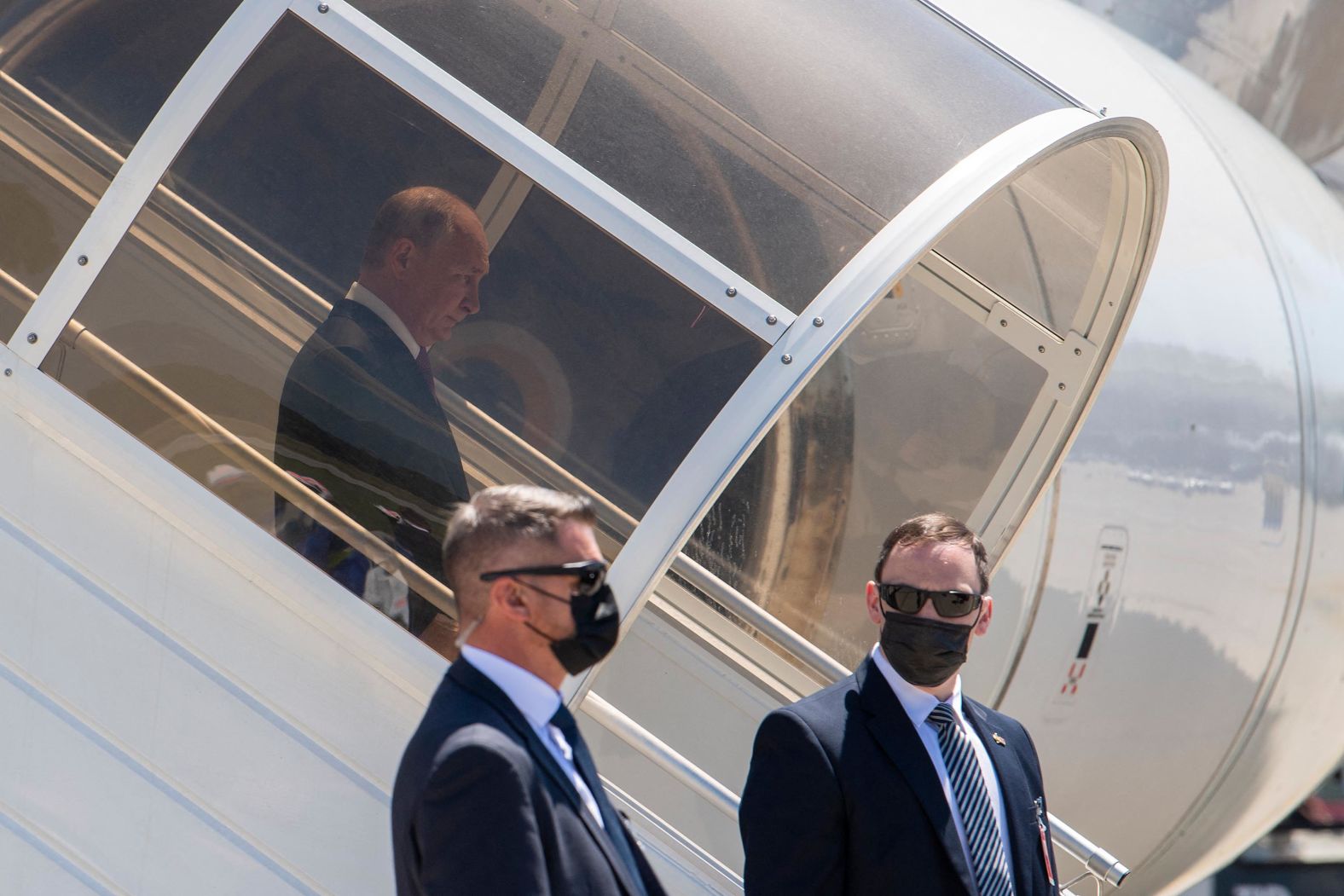 Putin steps down the stairs from his airplane after arriving in Geneva.