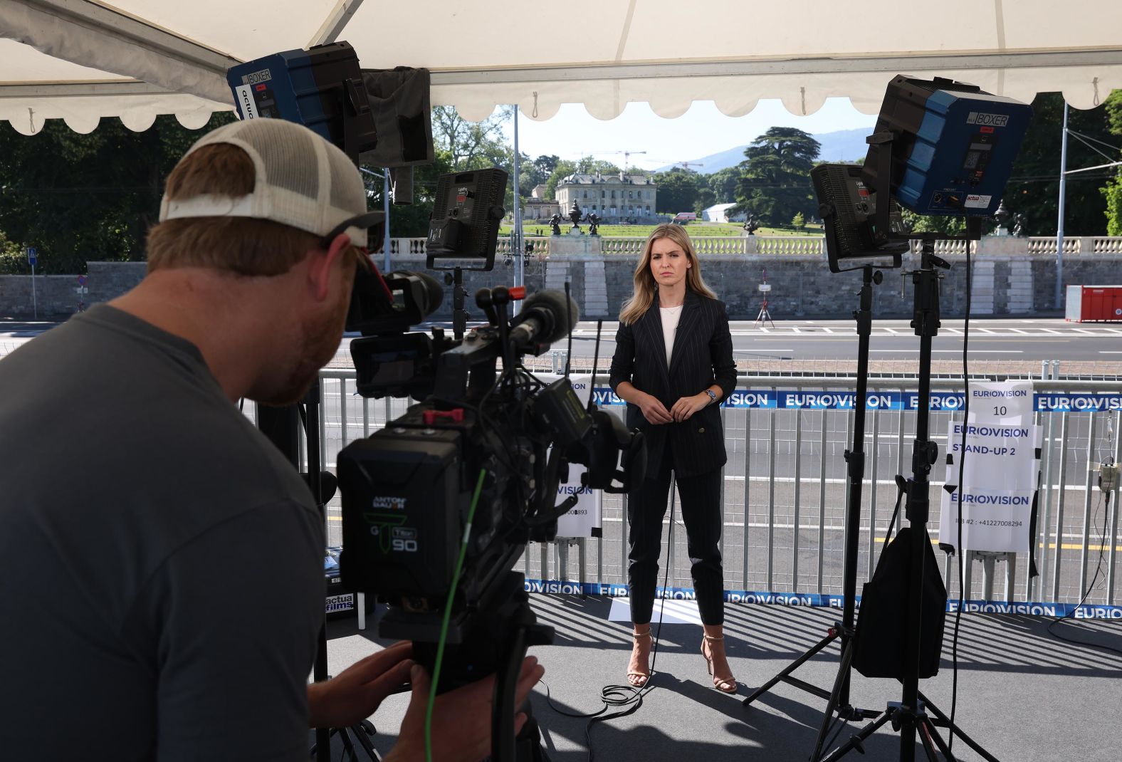 A Eurovision reporter stands outside Villa la Grange before the summit.