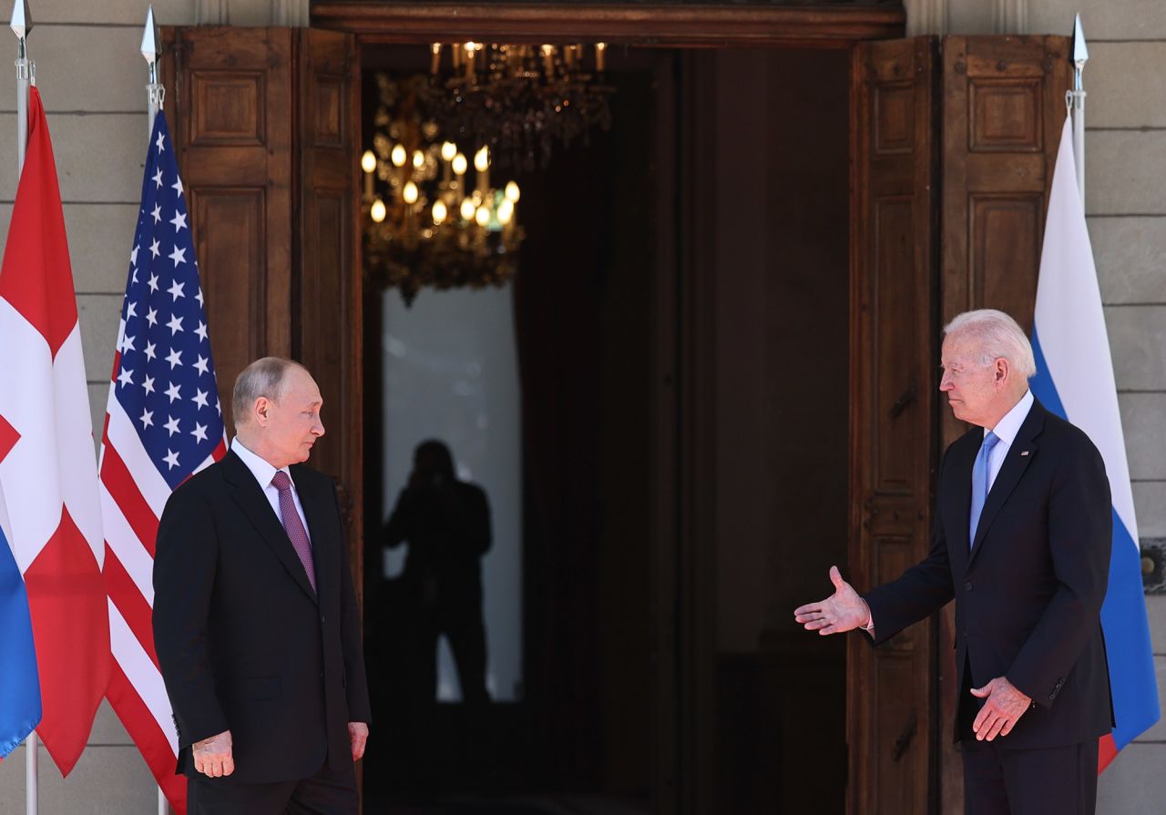 Biden reaches out to shake Putin's hand.