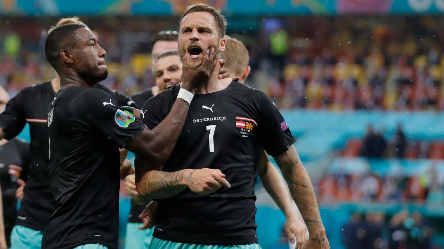 Austria's Marko Arnautovic, right, celebrates after scoring his side's third goal during the Euro 2020 match against Northern Macedonia.